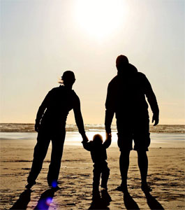 Family at the beach during sunset.